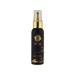 Elegant black and gold spray bottle with floral design.