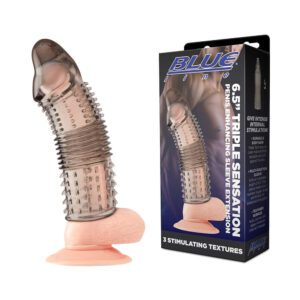 Textured male enhancement sleeve with suction base beside its packaging.
