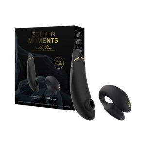 A black personal massager with packaging in the background.