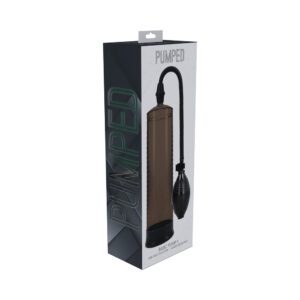 Black handheld air pump with a bulb and hose in packaging.